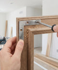 Installing Heavy Duty L Shaped Corner Brackets For Woodworking Right Angle Metal Braces on wood frame with screwdriver