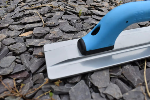 Pro-Grade Magnesium Concrete Float 3-1/8 x 16 In with beveled ends and rounded corners on gravel surface