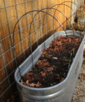 Image showing All Purpose Garden Hoop Kit With 5 Sets Of 7 Foot Fiberglass Hoops For Raised Beds Rust Proof Frame with leaves inside bin.