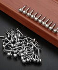 Kick Your Home Decor Up A Notch With These Legit Tough Vintage Silver Upholstery Nails 100 Piece Zinc Alloy Furniture Tacks on a black background.