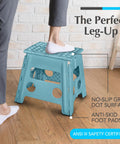 Person stepping on teal 13-inch foldable step stool with 300 lb capacity in home setting, featuring non-slip surface and anti-skid pads.