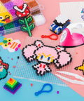 ACHENYUANYUAN Mini Heat Press Machine With Charging Base For DIY Crafts next to vibrant perler bead designs and crafting tools.