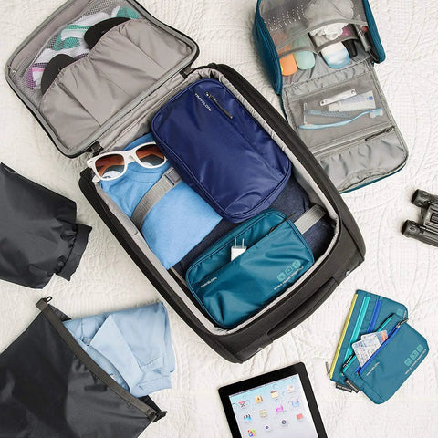 World Travel Essentials Tech Organizer for cords and gadgets with multiple interior pockets in open suitcase on white background