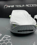 Badass Heavy Duty Weatherproof Car Cover For Tesla Model X silver microfiber cover fitting snugly over the vehicle inside a garage.
