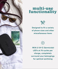 UVC Portable Sanitizer Box With Rechargeable Battery Kills Ninety Nine Point Nine Percent Germs On The Go Fits Masks Makeup Brushes Glasses Phones Keys Black next to phone and sunglasses.