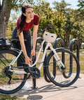 Woman securing bike with Bike Cable Lock 6 Feet By Half Inch With Resettable Four Digit Combination And Black Vinyl Coating at rack.