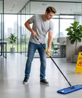 Heavy Duty 24 Inch Microfiber Dust Mop Kit With 61 Inch Extendable Handle And Two Quick Swap Pads For Top Shelf Floor Cleaning being used in an office.