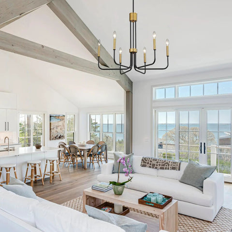Six Light Black And Gold Farmhouse Chandelier For Dining Room And Kitchen Island hanging in modern coastal living space.