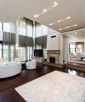 Modern living room with Kickin Recessed Downlight Kit For Easy Install 5 To 6 Inches, hardwood floor, white rug, and sofa.