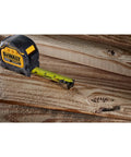 Tough Series 25 Ft Tape Measure With Magnetic Clip And Double Sided Blade Pro Grade Heavy Duty Housing on wooden surface