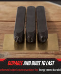 Close-up of three letter steel punches from 36 Piece Letter And Number Steel Punch Stamp Set With Wood Storage Case For Metal Leather And More