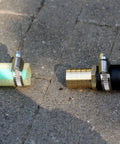 Solid Brass Garden Hose Repair Kit With Three Quarter Inch Barb Fittings And Six Stainless Clamps on concrete surface