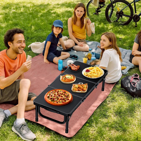 Group enjoying a picnic with food on a Three Foot Low Folding Picnic Table With Thick Aluminum Build, 10.3 Inch High