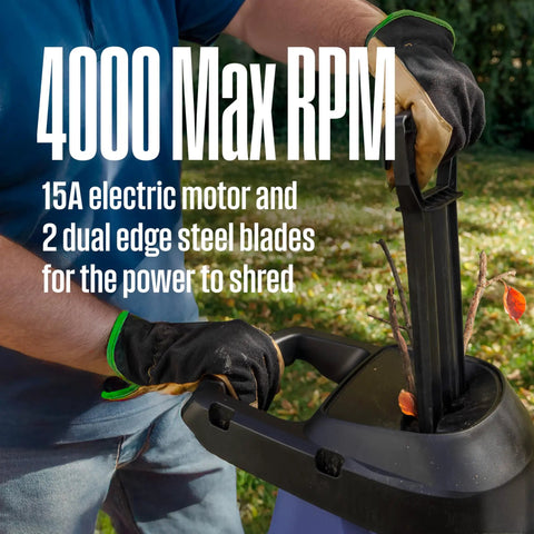 Person using Corded Electric Wood Chipper Shredder Be The Yard Boss With 1.7 Inch Capacity And 15 Amp Motor, inserting branch