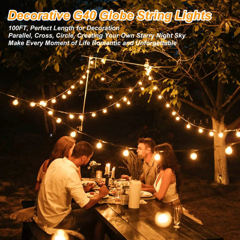 Dining setting lit by 200ft Outdoor G40 LED Globe String Lights with 103 bulbs, dimmable, waterproof, creating warm atmosphere.