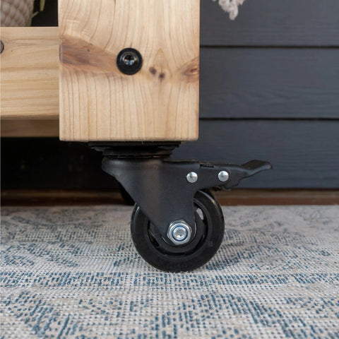 Close-up of caster wheel on 48 Inch Cedar Wood Buffet Hutch Serving Station With Galvanized Steel Countertop, Wine Rack And Glass Rack.