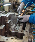 Technician using Badass Air Die Grinder With Extended Long Shaft For Tight Squeeze Tasks on engine component for precision carving.