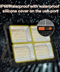 Portable Solar LED Work Light 100W With 336 LEDs, 15000 Lumens, IP66 waterproof silicone cover, USB port detail, rain background