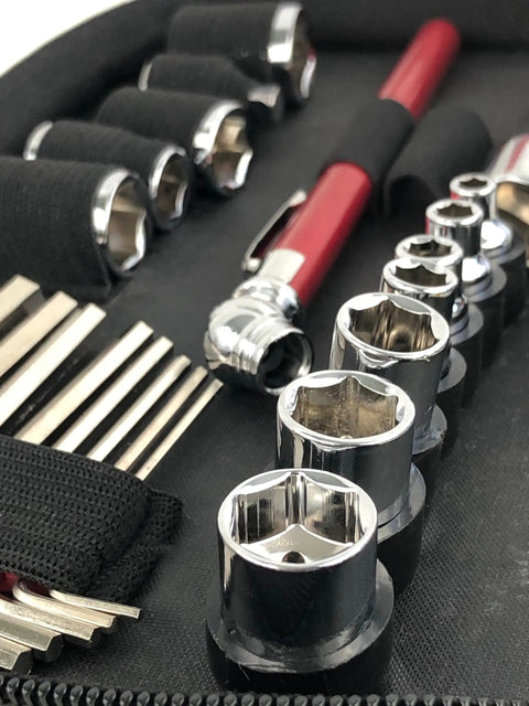 Close-up of 56 Piece Compact Metric Auto Tool Set In Zippered Case with sockets, hex keys, and red tool handle for roadside repairs