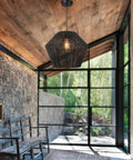Handwoven Rattan Basket Shade Boho Chic Pendant Light 16.5 Inch Matte Black Modern Farmhouse Coastal Chandelier in sunlit room
