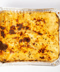 Baked lasagna in 35 Pack 8x8 Aluminum Pans With Clear Lids Square Foil Pans For Baking Heating Storing And Meal Prep Durable.