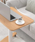 Real Slick Mobile Adjustable Standing Desk With Buttery Smooth Rollaway Casters, Ergonomic Height Adjusting Computer Cart and Cozy Bedroom Side Table For Zero Fuss Home Office Flow, Straight Up Game Changer on wooden surface with laptop and coffee cup.