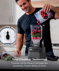 Top Shelf Professional Blender With 1200 Watt Motor And Auto Iq Technology 72 Oz Pitcher For Smoothies And Shakes filled with fruits.