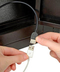 Person connecting USB cable in Eight Door Smartphone Charging Locker Featuring Sturdy Steel Build And Handy Power Outlets.