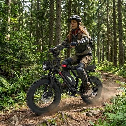 Woman riding 1500W Peak Electric Fat Tire Mountain Bike for Adults with 20 Inch Fat Tires and Full Suspension on forest trail
