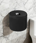 Full Enclosure Toilet Paper Holder Keeps Your Roll Safe From Hairy Paws And Chewy Jaws, black round fabric cover mounted on tile wall.