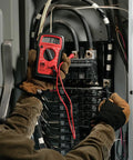 Technician using Digital Multimeter 4 Function 14 Range For AC DC Voltage Resistance And Battery Testing Manual Ranging Auto Off Durable Drop Resistant Housing Three And A Half Digit Display With Secure Input Jacks Must Have Toolbox Essential on electrical panel.