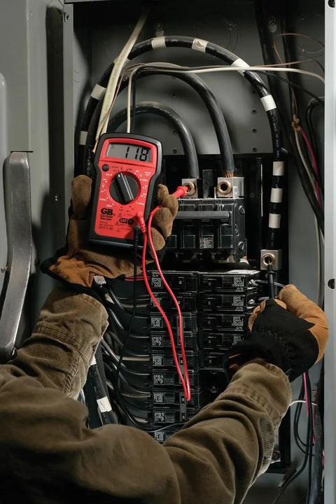 Technician using Digital Multimeter 4 Function 14 Range For AC DC Voltage Resistance And Battery Testing Manual Ranging Auto Off Durable Drop Resistant Housing Three And A Half Digit Display With Secure Input Jacks Must Have Toolbox Essential on electrical panel.