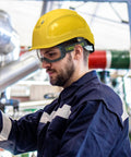Worker wearing MX500 Safety Goggles With 23 Percent Gray Tint, Adjustable Cloth Strap, TruShield Anti Fog Coating; outdoor setting