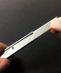 Close-up of hand snapping blade of ABS Grip 30-Degree Multi-Blade Cartridge Knife, 9mm Snap-Off Utility Knife, showing blade detail.