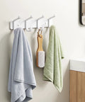 Hella Sturdy Wall Mount Coat Rack Featuring Heavy Duty Double Steel Hooks For Backpack Storage And Rust Proof Coating For Mudroom Storage That Handles Maximum Load Zero Fuss, displaying towels and a hairbrush in a bathroom.