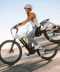 Rider on a bicycle with Two Pack Motorcycle Bell Set With Gift Box And Legend Card, Weatherproof Badass Good Luck Charm For Riders visible.