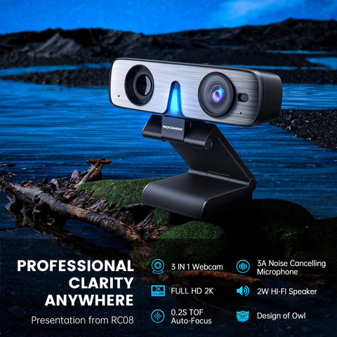 Premium 2K Webcam With Built In Speaker And Noise Canceling Mic, angled view on a stand near water, showcasing design and features.