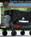 Double-layer camping trailer with a lid loaded with gear outdoors, featuring black frame and mesh pockets for storage.