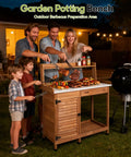 Outdoor Potting Bench Table for the Garden with Weatherproof Wooden Work Station Heavy Duty Metal Top being used for barbecue