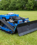 Remote Control RC Tracked Lawn Mower For Slopes And Uneven Terrain in grassy yard with front blade and tracked wheels.