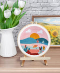 Punch Needle Kit For Adults And Beginners, DIY Landscape Embroidery Set displayed on easel, with flowers and painting.