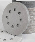 Premium 5 Inch Sanding Discs With 8 Holes For Dust Free Grinding Super Grip Hook And Loop Backing stacked showing texture