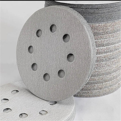 Premium 5 Inch Sanding Discs With 8 Holes For Dust Free Grinding Super Grip Hook And Loop Backing stacked showing texture