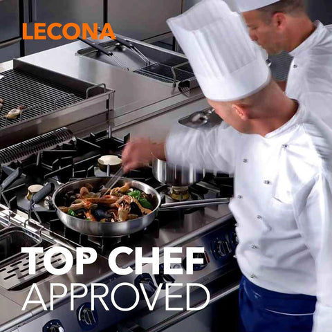Professional chefs cooking on industrial stove with gas burners, demonstrating culinary expertise in a commercial kitchen.