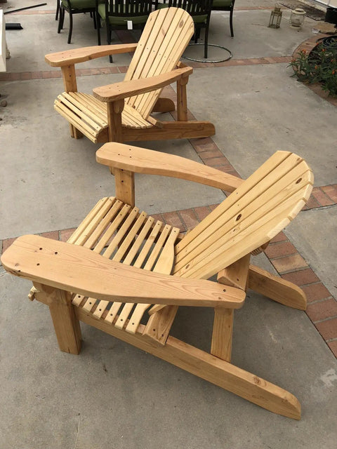 Classic Adirondack Chair Plans With Full Size Templates Total No Sweat Weekend Build For Your Backyard Lounge Easy To Tackle Alone Or With Buddies. Two wooden Adirondack chairs with a slatted design on a patio.