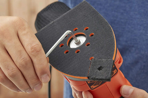 Person adjusting the sanding head of the Pick Up This Bad Boy Heavy Duty Multi Sander With 200 Watt Motor, 4 In 1 Orbital And Finger Sanding Heads.