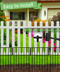 10 Pack No Dig Animal Barrier Fence For Gardens And Yards Rustproof Metal Bottom Blocker Border Fence Seventeen Inch High And 10Ft Long Decorative Outdoor Fence shown installed in front of a white picket fence with a mallet in hand.