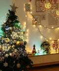 Christmas tree with Lit 4 Pack Firework LED Copper Wire Star String Lights, 8 modes, in festive room decor setting.