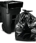 Hella Tough 95 Gallon Contractor Garbage Bags Built Like Armor For Industrial Sites With Easy Tie Necks Top Shelf 2 Mil Trash Can Liners Workhorse Strength Pack Of 25 next to a black trash bin.