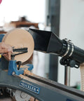 Premium Woodturning Dust Extraction Hood Featuring Flexible Rubber Cuff Universal Mount For Lathes And Turning Tools with wood chips.